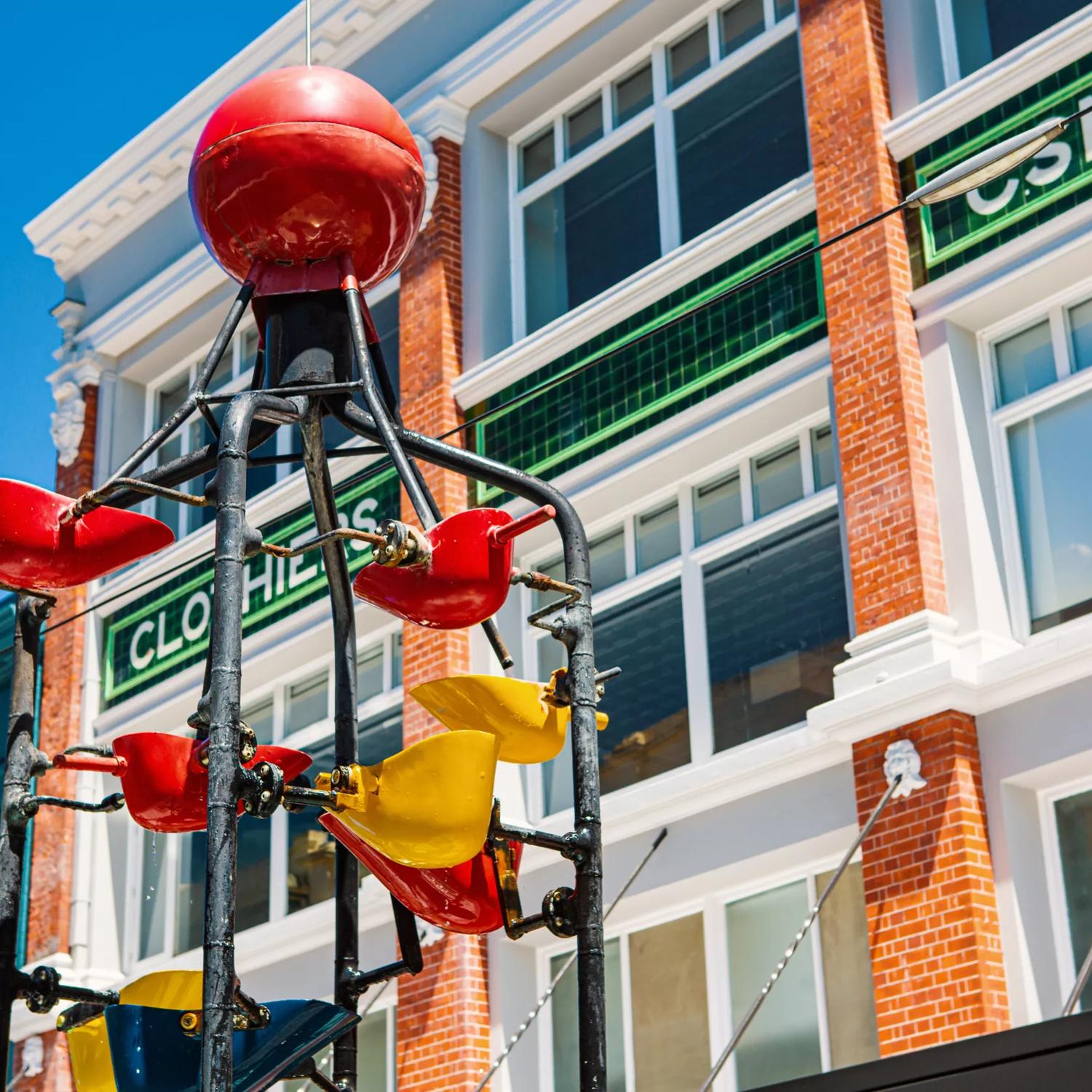 Looking up at the Bucket Fountain during the day, an iconic kinetic sculpture located in Cuba Mall in Wellington.