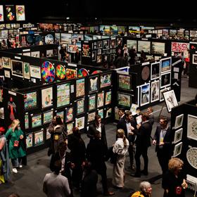 A crowded maze of walls covered in contemporary art pieces on display at the NZ Art Show.