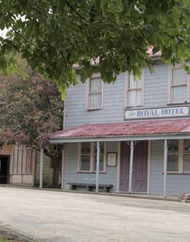 The screen location of Whiitemans Valley, nestled among trees and hills, old buildings have been built to mimic an old town.