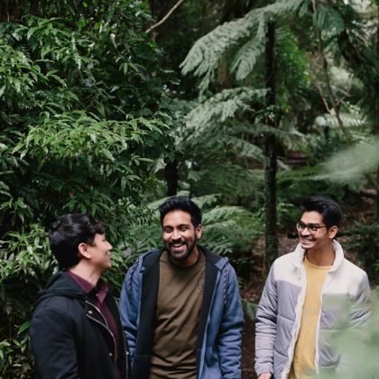 Three people are standing together on the Ōtari-Wilton's Bush walk.