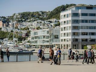 People walking along the waterfront by Harbourside Markets.