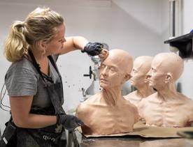 A special effects makeup artist sculpting head caste at Wētā Workshop.