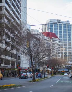 The mix of modern and old buildings along Lambton Quay, including the old supreme court, and old bank.