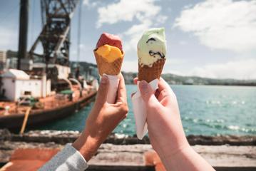 2 hands holding up ice creams from Gelissimo Gelateria on the Wellington Waterfront.