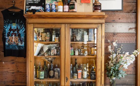 A cabinet of antiques inside Thistle Inn.
