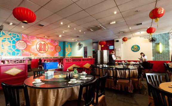 Interior of Dragons restaurant, with chinese cultural items around the room.