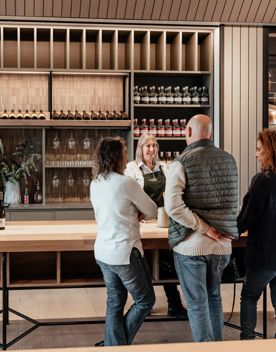 Four people enjoying a wine tasting at The Runholder