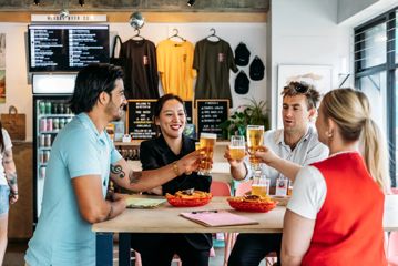 Four friends raise their glasses at Heyday Beer Co.