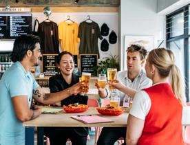 Four friends raise their glasses at Heyday Beer Co.