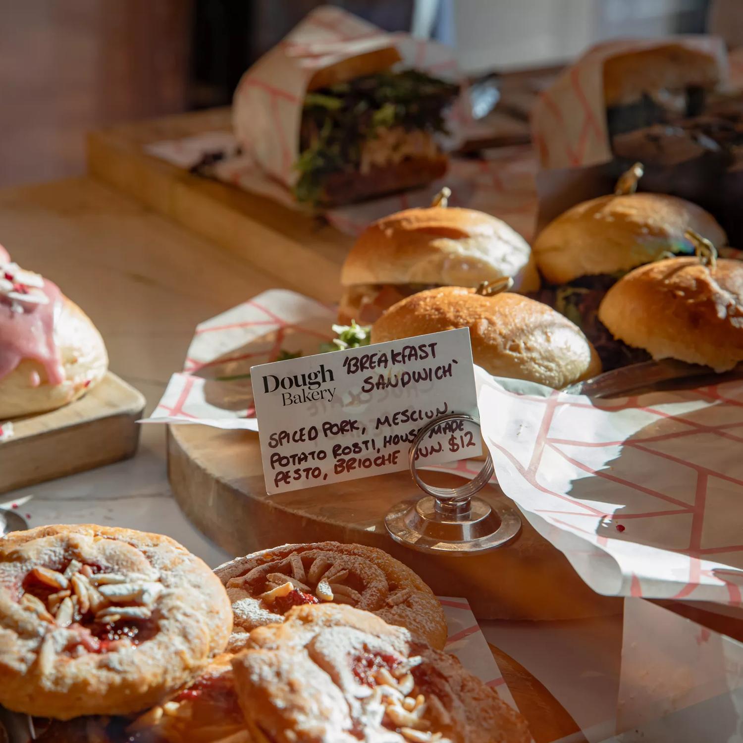 A close up of the cabinet food inside Dough Bakery Upper Hutt, featuring a breakfast sandwich.