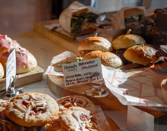 A close up of the cabinet food inside Dough Bakery Upper Hutt, featuring a breakfast sandwich.