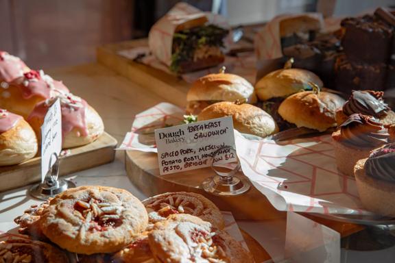 A close up of the cabinet food inside Dough Bakery Upper Hutt, featuring a breakfast sandwich.