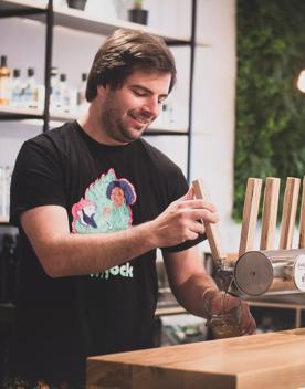 A bartender wearing a black t-shirt pours a pint of craft beer at Waitoa, a bar on Victoria Street in Te Aro, Wellington.