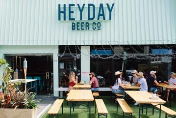 Heyday Beer Co. on Upper Cuba Street in Te Aro Wellington. People enjoy drinks at the picnic tables on the front patio.