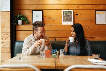 Two people enjoy a flight of coffee at The Hangar.