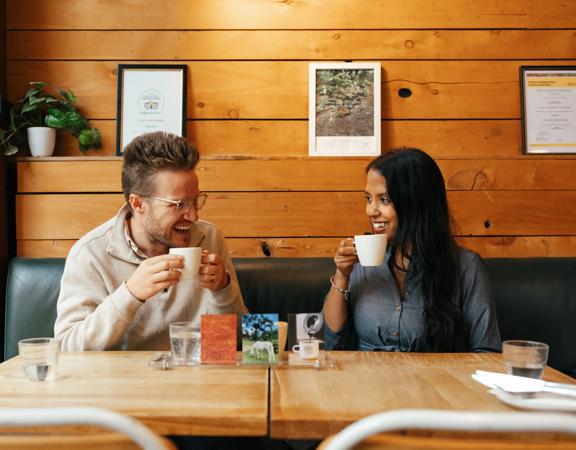 Two people enjoy a flight of coffee at The Hangar.