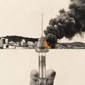 In an off-white and black photo collage, a hand holds a syringe vertically, the top of the needle aligns with the New Zealand Parliament building, and Wellington's downtown is billowing with smoke. 