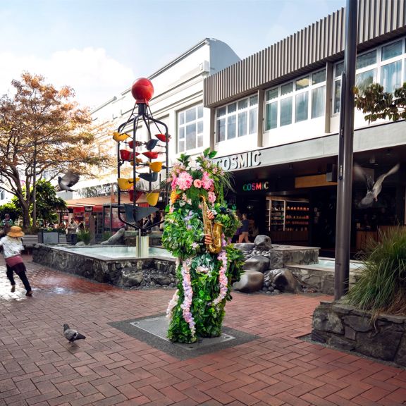 Tree person playing a saxaphone on Cuba Street in Wellington