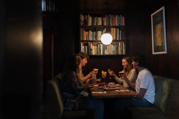 Diners gather in a cosy booth at The Library bar on Courtenay Place in Wellington.