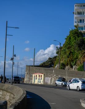 The screen location of Oriental Bay, wth pastel-coloured, Art Deco apartments, brightly-painted boat sheds, and the golden beach.