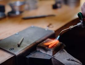 A small piece of metal is being heated at Rawson Brothers Jewellery in Upper Hutt.