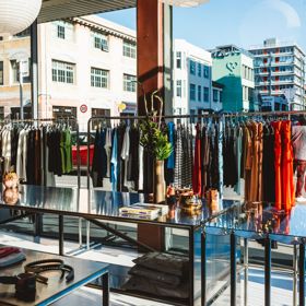 Racks of clothes are positioned in front of Sully's shop windows, looking out on Ghuznee Street.
