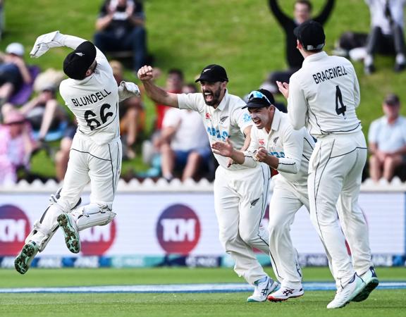 New Zealand wicketkeeper Tom Blundell celebrates after taking a catch to dismiss Ben Duckett of England during a test match.