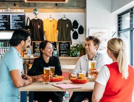 Four friends enjoy beers and fries at Heyday Beer Co.