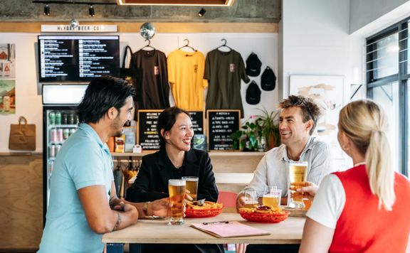Four friends enjoy beers and fries at Heyday Beer Co.
