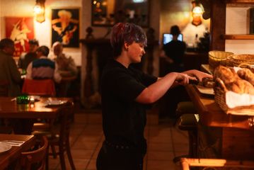 A person cutting fresh bread at Cicio Cacio Osteria in Newtown, Wellington