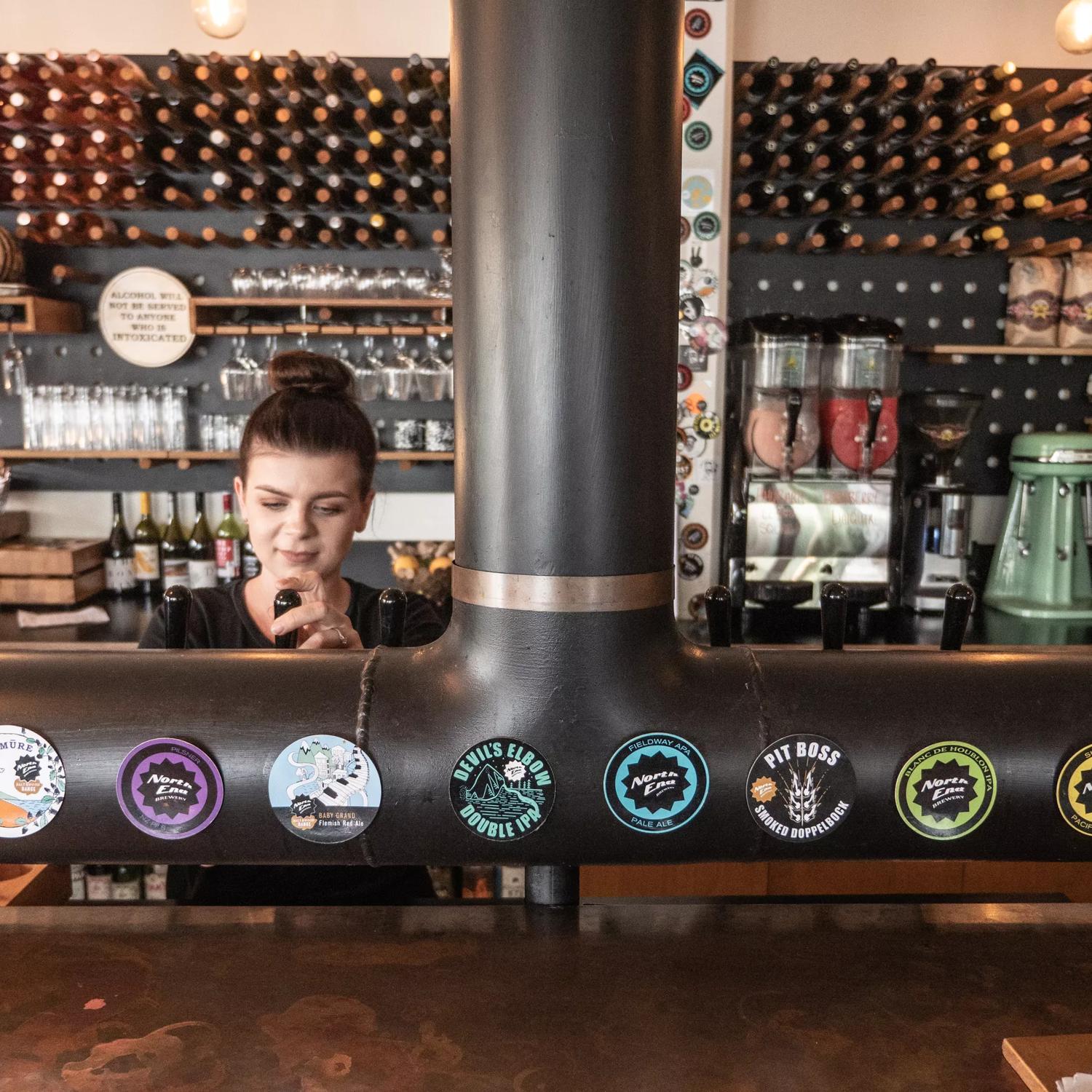 Bar staff at Salt and Woof / North End Brewery pouring a drink from the tap.