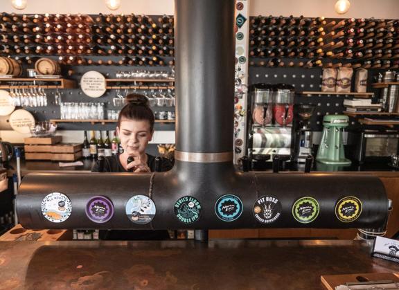 Bar staff at Salt and Woof / North End Brewery pouring a drink from the tap.