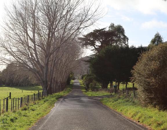 Mangaroa Valley Road screen location, a scenic rural setting with native forest, farmland, and a mountainous backdrop.