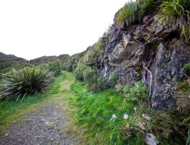 The screen location of Remutaka Summit, wit views of surrounding peaks, lush green bush and steep roads cut into the sides of the mountains.