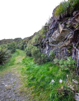 The screen location of Remutaka Summit, wit views of surrounding peaks, lush green bush and steep roads cut into the sides of the mountains.