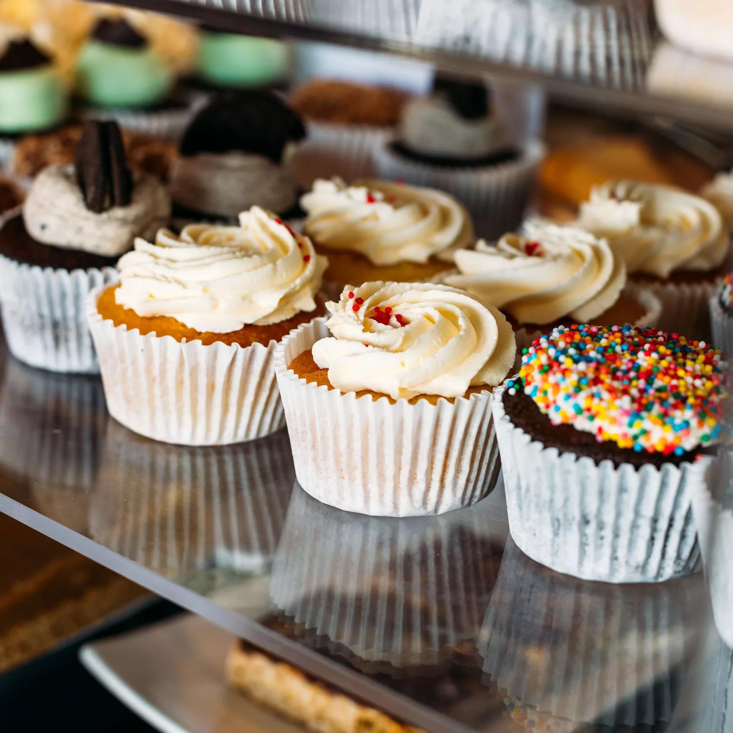 Cupcakes inside a cabinet at The cake Cafe Plimmerton.