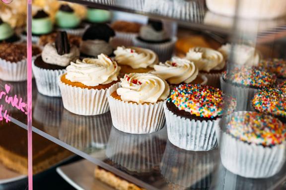 Cupcakes inside a cabinet at The cake Cafe Plimmerton.