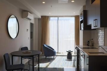 Internal room of Ramada showing kitchenette and floor-to-ceiling window.