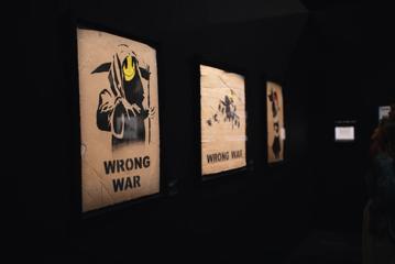 'Wrong War' (2004), screen prints in colours on brown card, displayed at The Art of Banksy exhibition.