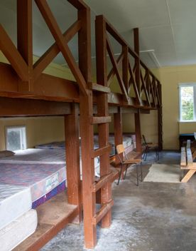 Camp Wainuiomata screen location. Has several buildings and is surrounded by forest and bush.