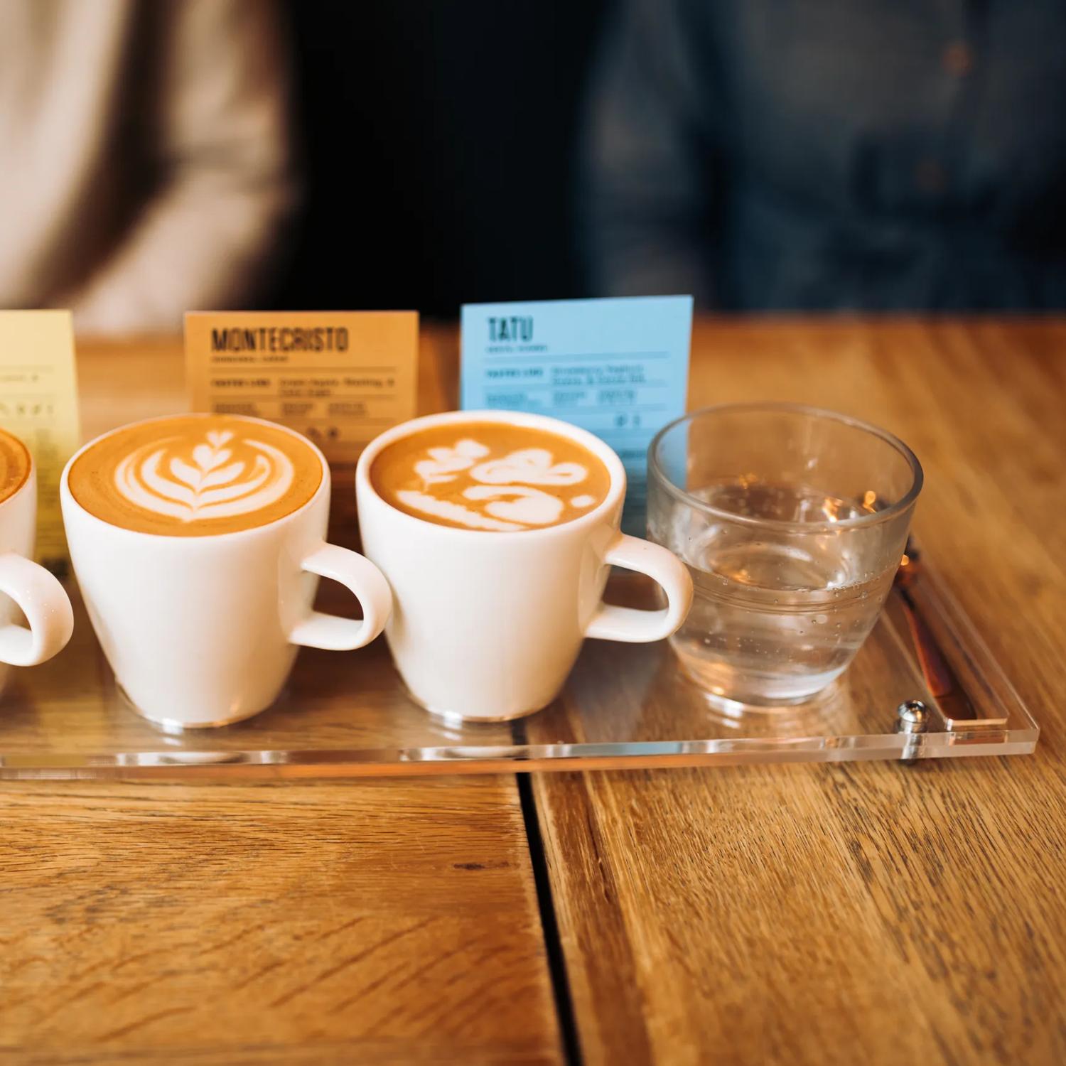 A flight of coffee and a glass of water.