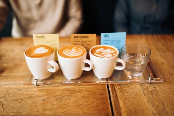 A flight of coffee and a glass of water.