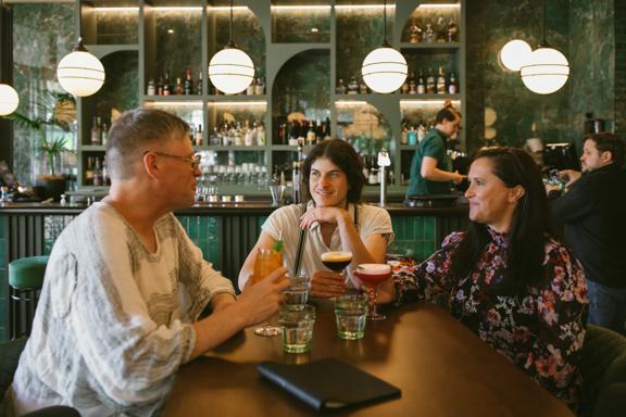 Three friends enjoy cocktails at Hummingbird Restaurant & Lounge.