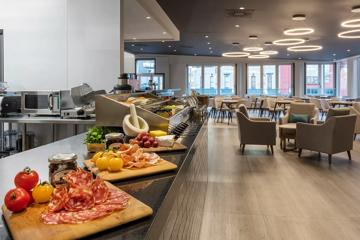 The dining room inside Oaks Wellington Hotel, with charcutiere boards laid out next to a sandwich bar.