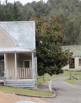 The screen location of Whiitemans Valley, nestled among trees and hills, old buildings have been built to mimic an old town.