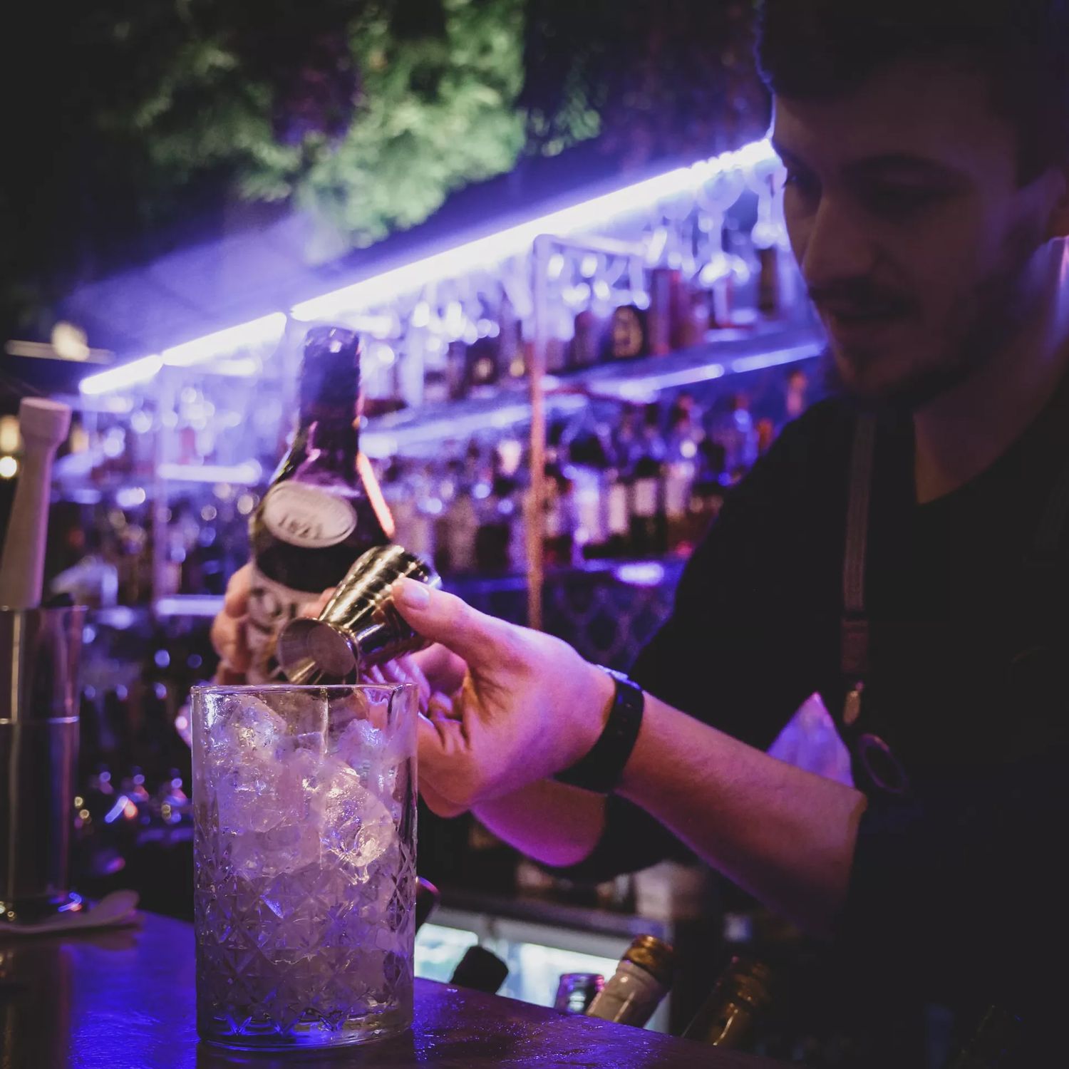 Close up of bar tender at Lulu creating a cocktail.
