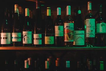 Bottles of wine for sale on a shelf at Puffin wine bar.