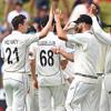 BLACKCAPS cricket players high-fiving on the pitch.