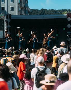 Hiwa, a Māori cultural group, perform on an outdoor stage at CubaDupa.