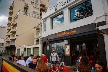 People enjoy the patio outside of Beach Babylon café.